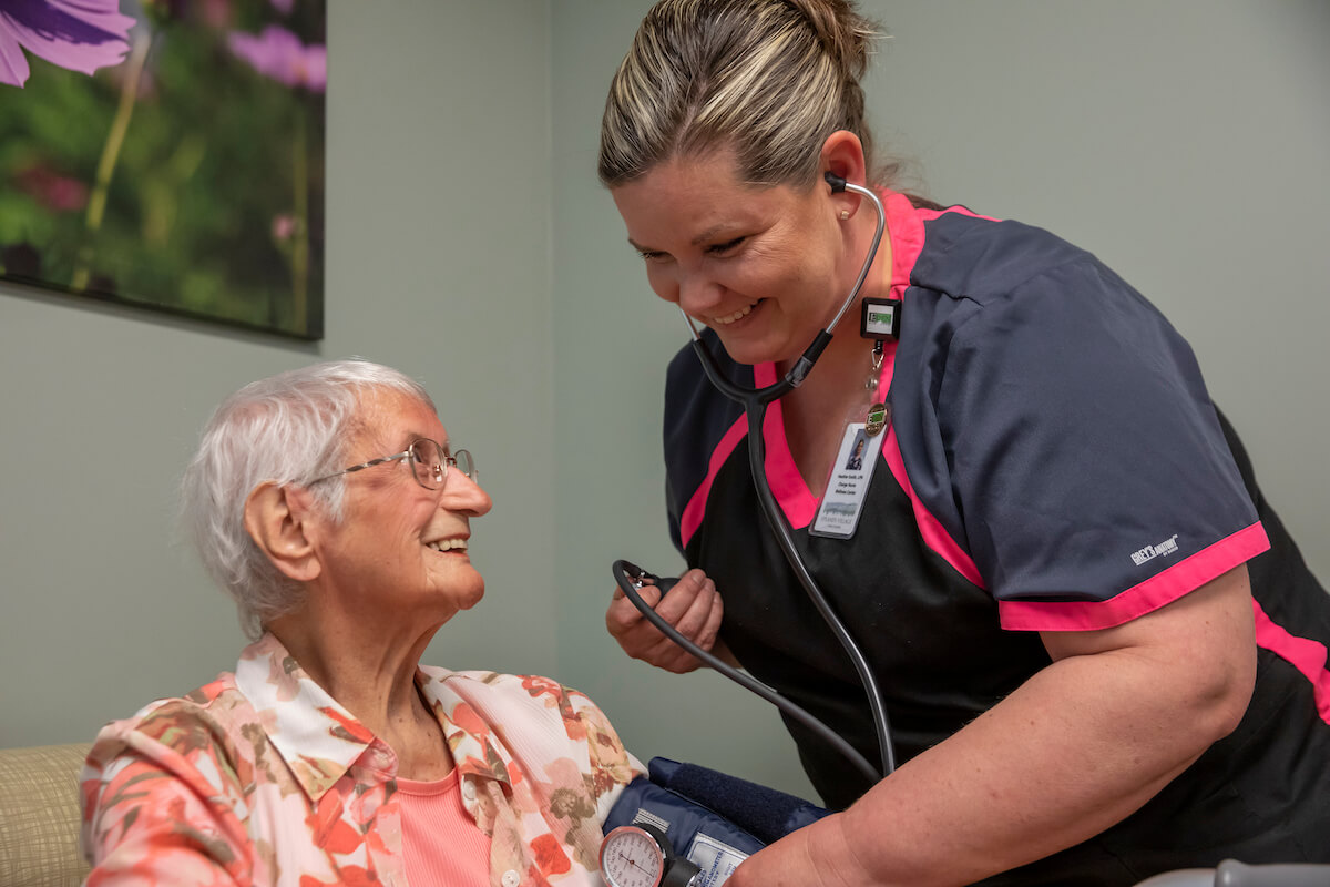 happy older woman with caregiver