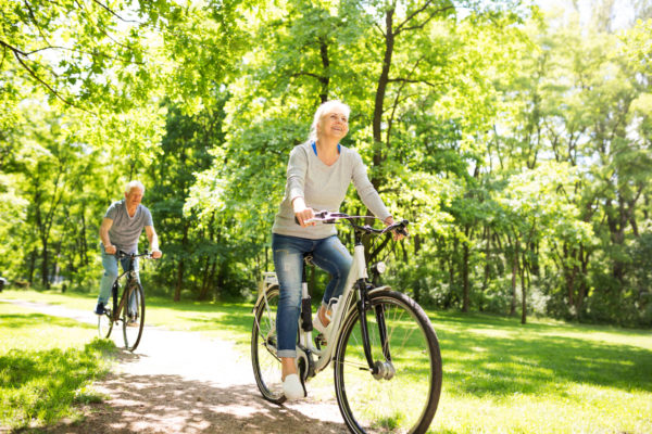 Uplands Village_Senior Couple Riding Bicycles Through Park