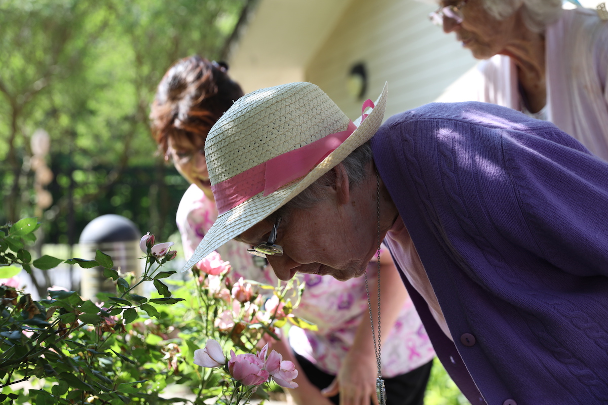 Senior Woman Smelling Flowers