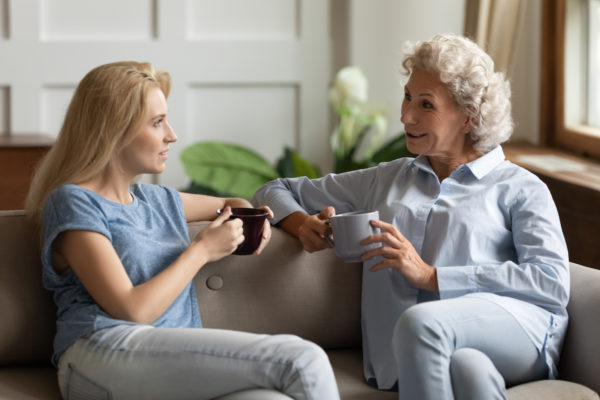 Senior Woman and Adult Daughter Talking on Couch_Uplands Village