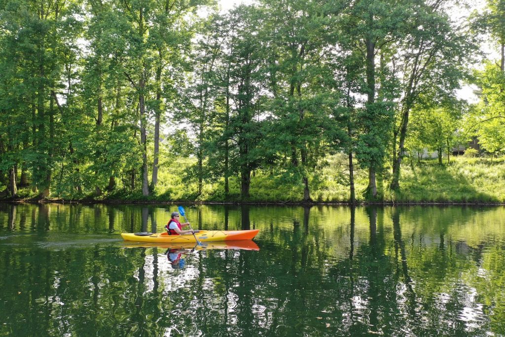 Senior Woman Kayaking on River_Uplands Village