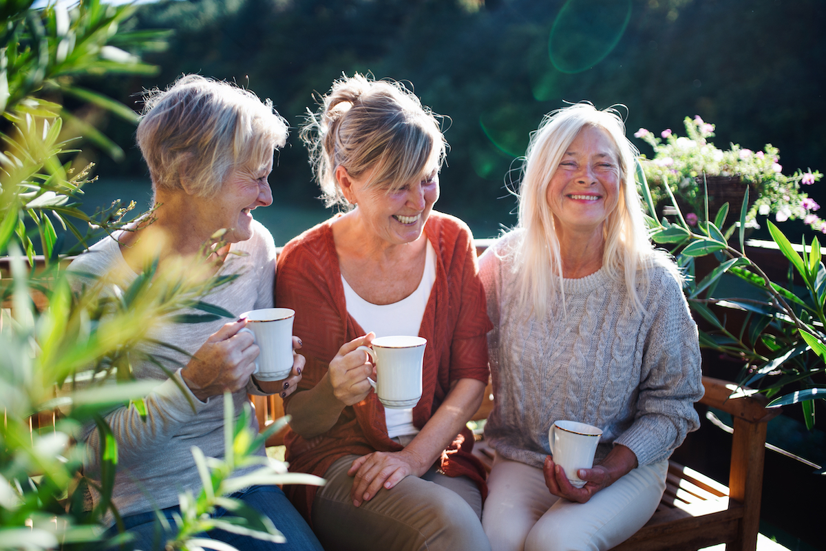 Senior Women Laugh and Drink Coffee_Uplands Village