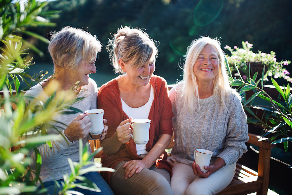 Senior Women Laugh and Drink Coffee_Uplands Village