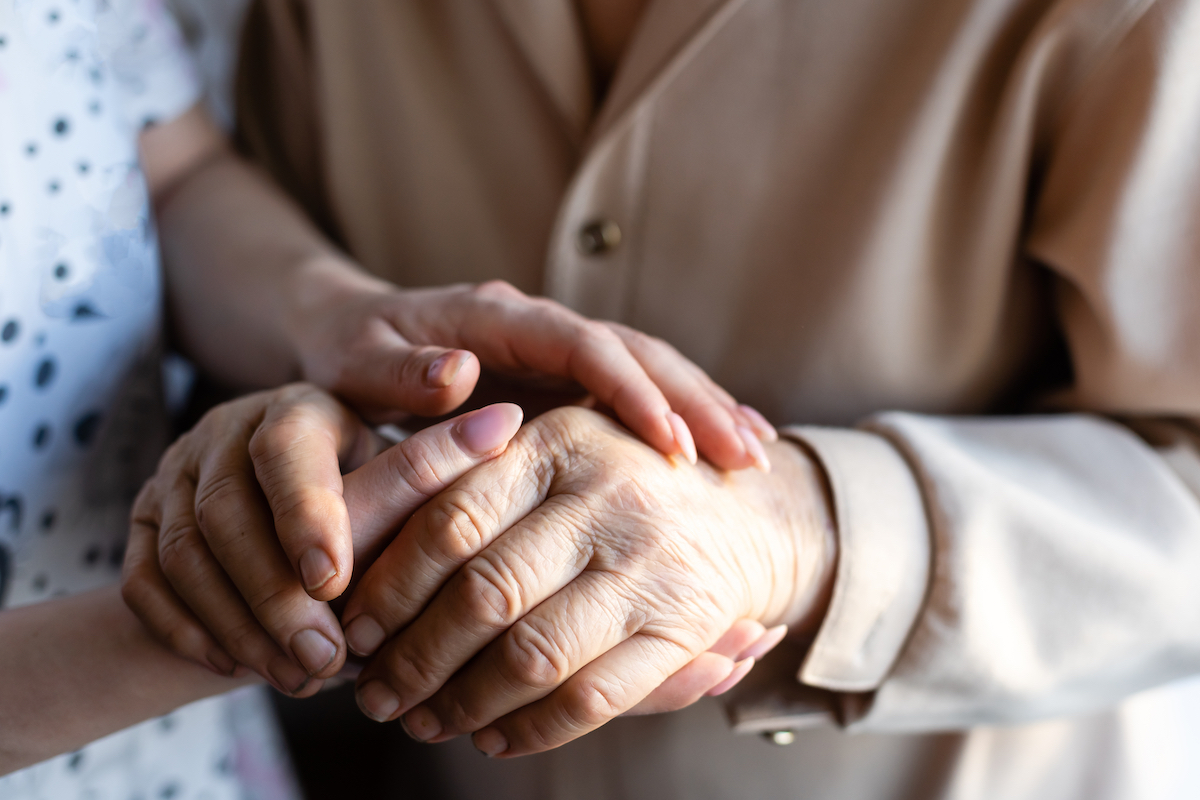 Close-Up of Senior Woman and Daughter Holding Hands_Uplands Village